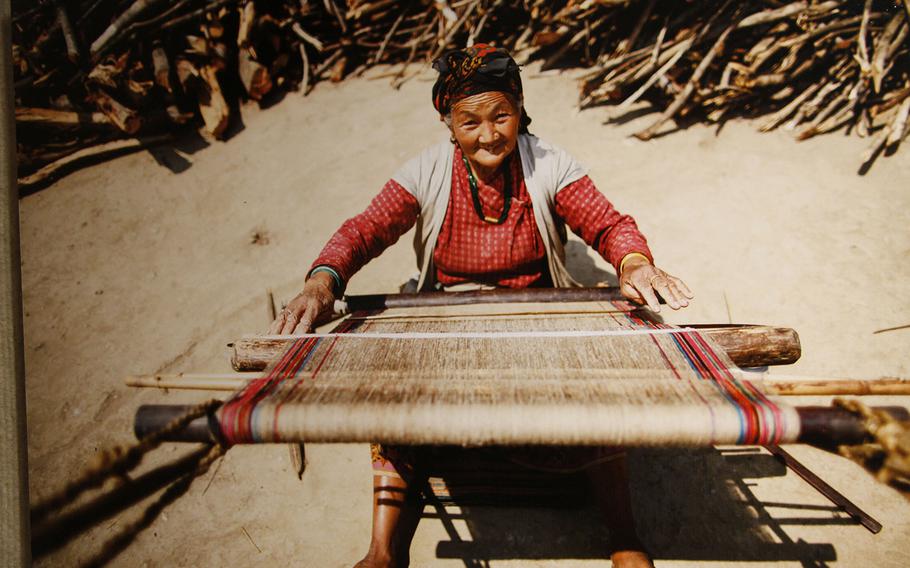 Fattiphool is one of the few women who still uses wild nettles as material for weaving into fabric on the back strap loom in the mountainous Rapccha Basa region. Most weavers now use cotton. This photo is included in the "Mountain Minorities" exhibit at Honolulu's East-West Center.