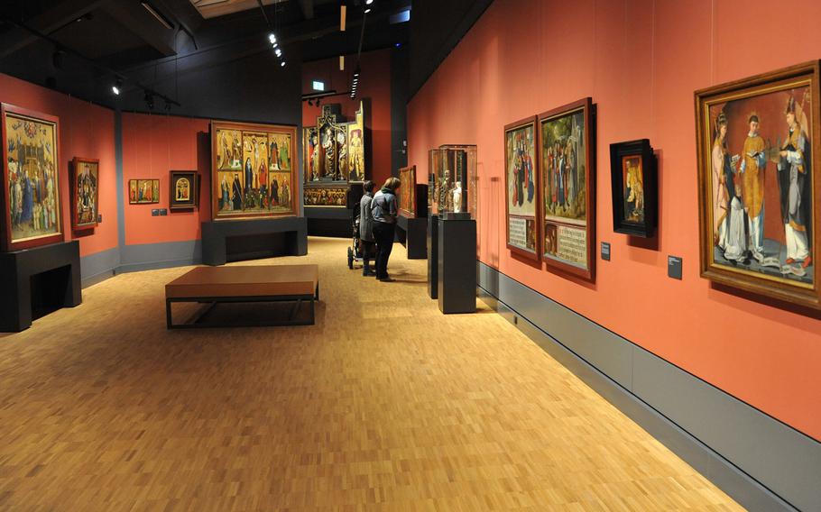 Visitors to the Hesse State Museum in Darmstadt, Germany, check out art from the 13th through 15th centuries in the museum's painting gallery.