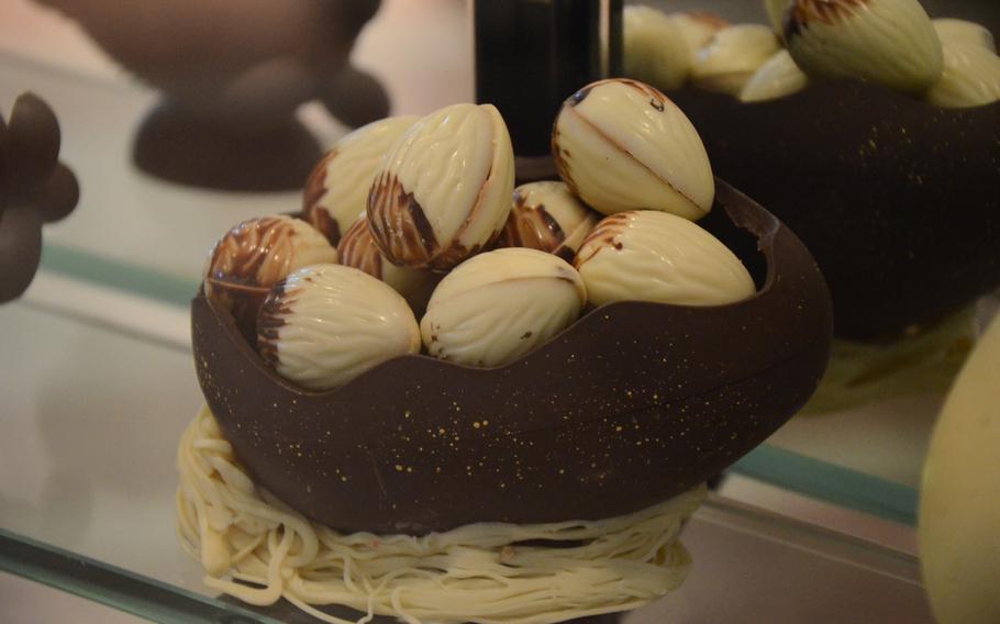 White chocolate walnuts fill a chocolate egg in a display window at Peratoner, a chocolate store in the walking district of Pordenone, Italy.