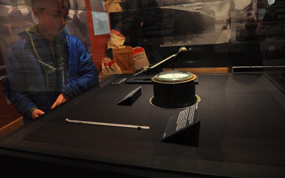 A boy looks at a ship barometer, one of nearly 250 artifacts from the Titanic salvaged from the sea floor that are on display until June 28, 2015, at the Historical Museum of the Palatinate in Speyer, Germany.