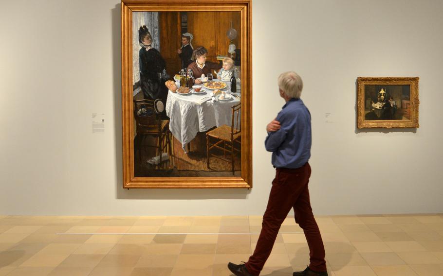 A visitor looks at Claude Monet's "The Luncheon" from 1868/69. This painting, along with another with the same name from 1873, are the centerpieces of the the "Monet and the Birth of Impressionism" exhibit at the Städel in Frankfurt, Germany.