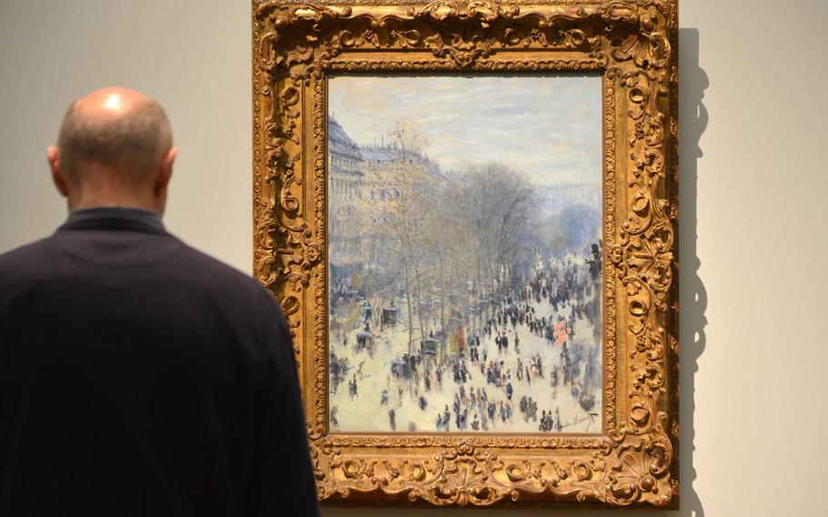 A visitor to the "Monet and the Birth of Impressionism" exhibit at the Städel in Frankfurt, Germany, takes a look at Claude Monet's "Boulevard des Capucines" from 1873/74. To art critics then and today it is an important piece of art, as for the first time it depicts the impression of a city in motion