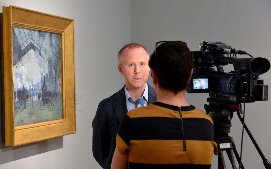 Felix Kämer, the curator of the "Monet and the Birth of Impressionism" exhibit at the Städel in Frankfurt, Germany, is interviewed standing in front of Claude Monet's "Saint Lazare Station. Arrival of a Train." The exhibit is open until June 21, 2015.