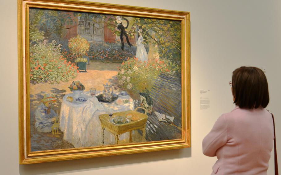 A visitor looks at Claude Monet's "The Luncheon" from 1873. This painting, along with another with the same name from 1868/69, are the centerpieces of the the "Monet and the Birth of Impressionism" exhibit at the Städel in Frankfurt, Germany.