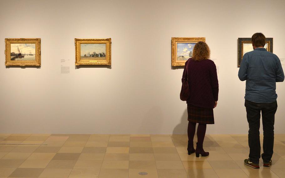 Visitors to the "Monet and the Birth of Impressionism" exhibit at the Städel in Frankfurt, Germany, examine the artworks on display. The exhibit runs until June 21, 2015.