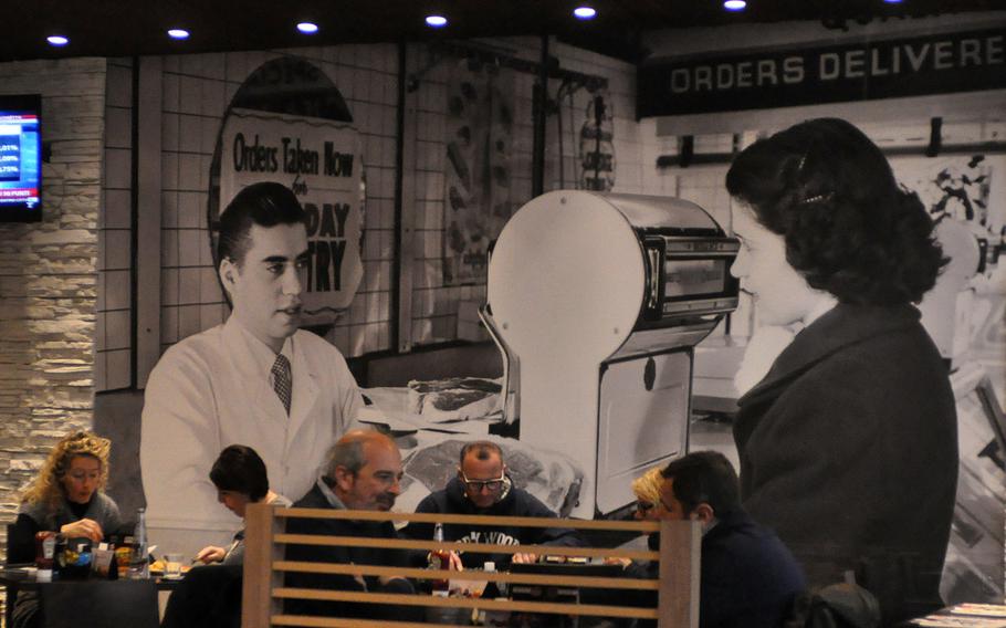 Scenes that could have been pulled out of a America several decades ago dot the walls of the Roadhouse Grill in the Tiare shopping mall near Villesse, Italy.