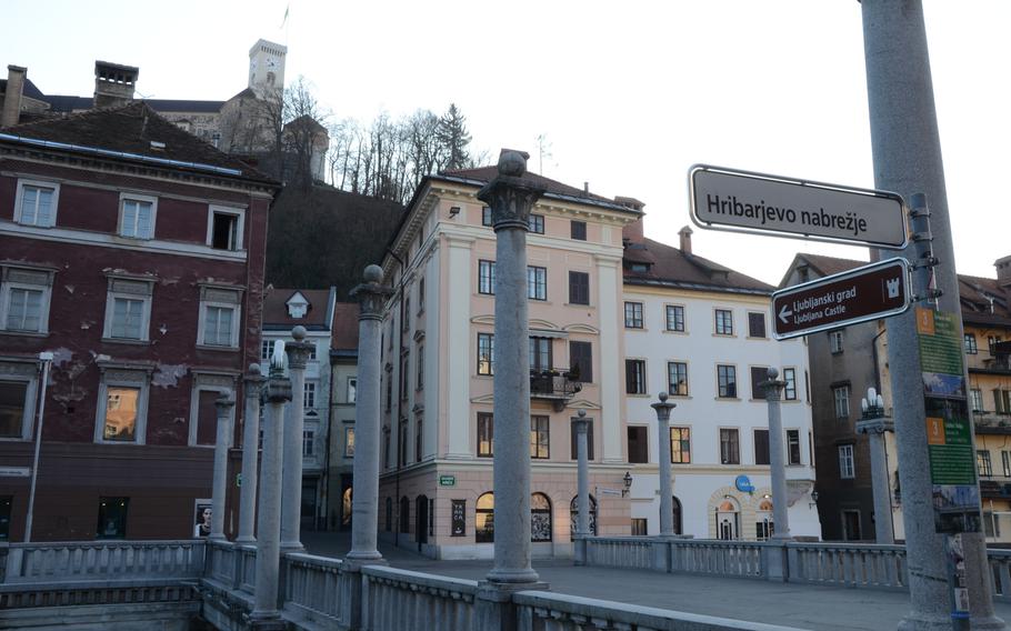 Brown street signs, such as the one posted here near the Cobbler's Bridge in the central part of Ljubljana, Slovenia, will lead you to the city's castle.