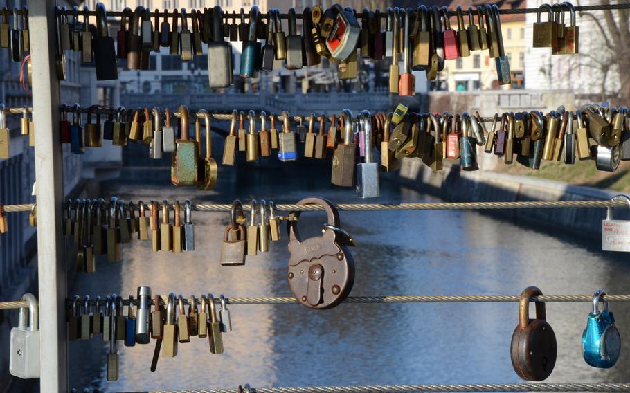 A variety of locks surround cables on the Butcher's Bridge, which spans the Ljubljanica River in Ljubljana, Slovenia.