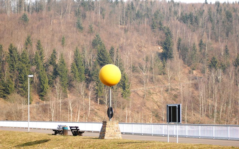 A sculpture of the sun marks the start of the Planetenwanderweg hiking trail in Nonnweiler, Germany. The trail is designed as a scale model of the solar system; hikers begin at the sun and pass markers bearing information about each planet.