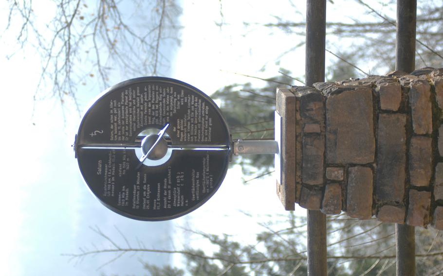 A marker with information about Saturn stands along the Planetenwanderweg hiking trail in Nonnweiler, Germany. The trail begins at a sculpture of the sun and offers markers bearing information about each planet in the solar system.