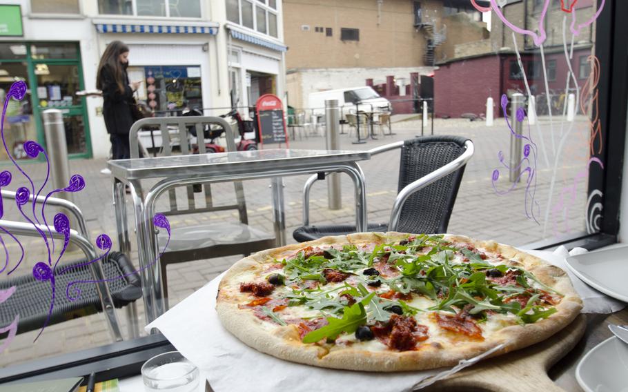 The Dr. Johnny Pizza from Charlie's Coffee Company in Cambridge, England, comes with pepperoni and "speck" (a type of bacon). The Dr. Johnny is one of about a dozen kinds of pizza offered by the restaurant.