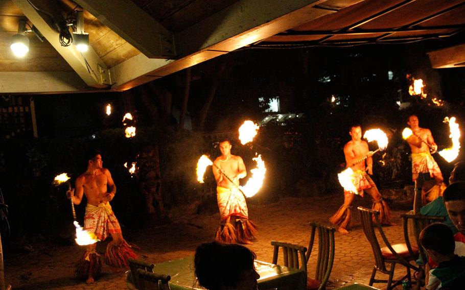 Fire dancers gather for the performance finale during dinner buffet at Makittii.

Wyatt Olson
Stars and Stripes