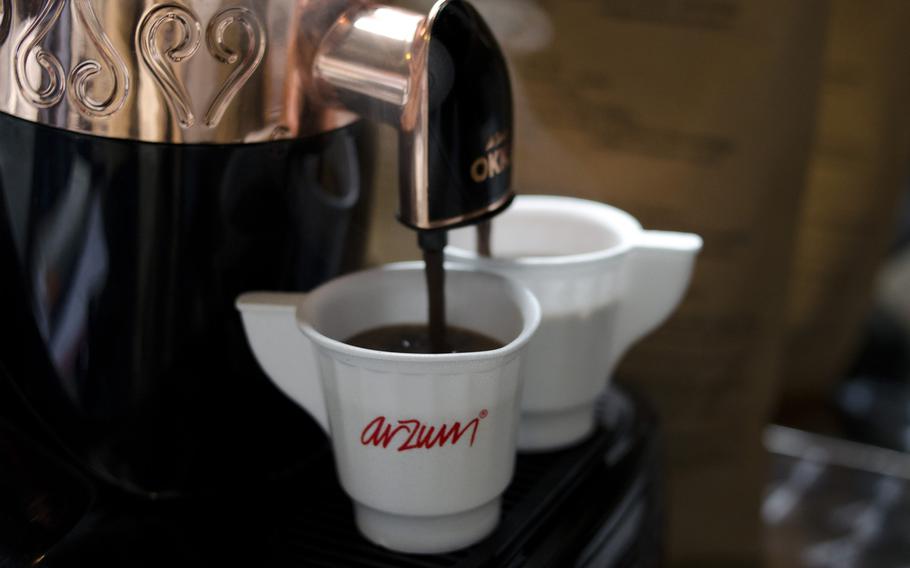 Turkish coffee pours into two cups at Arzum's stand at the 2014 London Coffee Festival on Saturday, April 5, 2014.