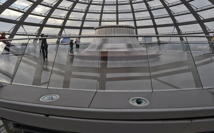 The  upper platform and roof of the Reichstag cupola. Ramps that spiral around the cupola, offer a 360-degree view of Berlin. The central mirrored cone can be used to draw light into the plenary chamber.
