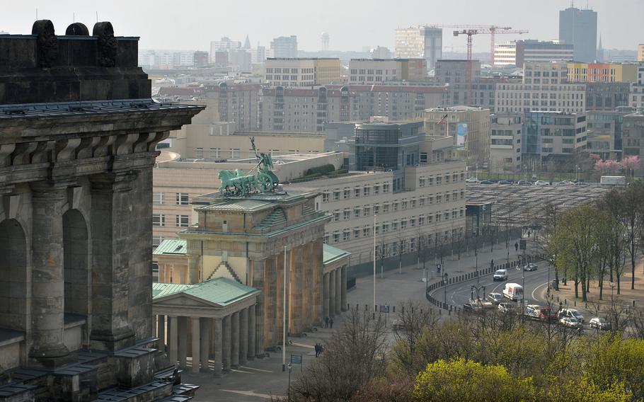 A view from the Reichstag's roof with part of one the building's four corner towers, the Brandenburg Gate, the American Embassy and the Memorial to the Murdered Jews of Europe.  