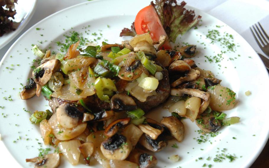 The obvious co-stars on the menu at Maxi Restaurant in Ramstein, Germany, are steak and roasted potatoes. Here, the Maxi steak with mushrooms and onions is shown. 