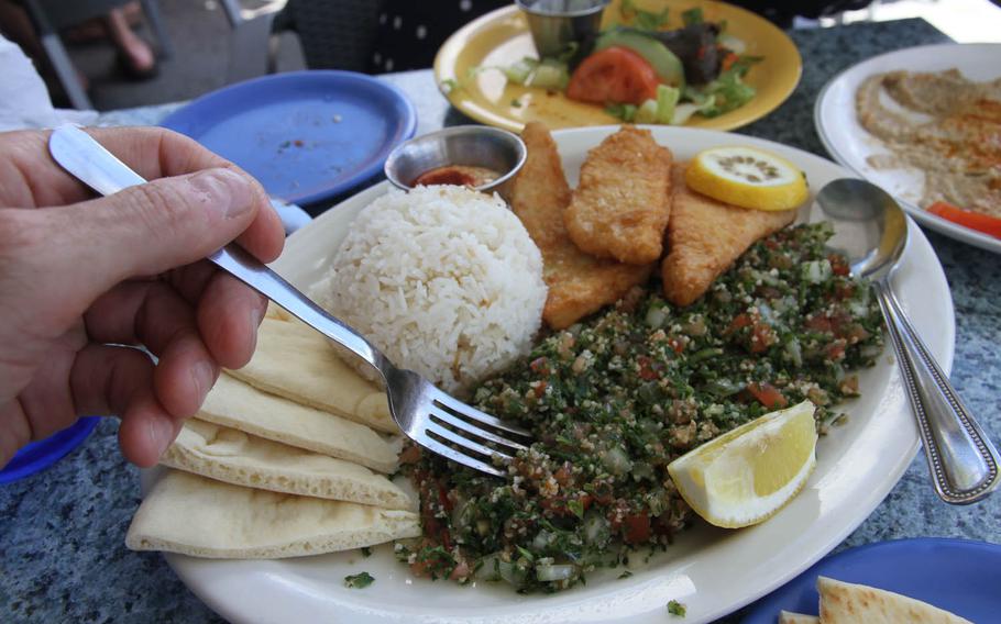 A heaping portion of tabouleh is the center of this lunch plate at Greek Marina restaurant. With it are calamari steak, rice, pita bread and a garlic dipping sauce.  