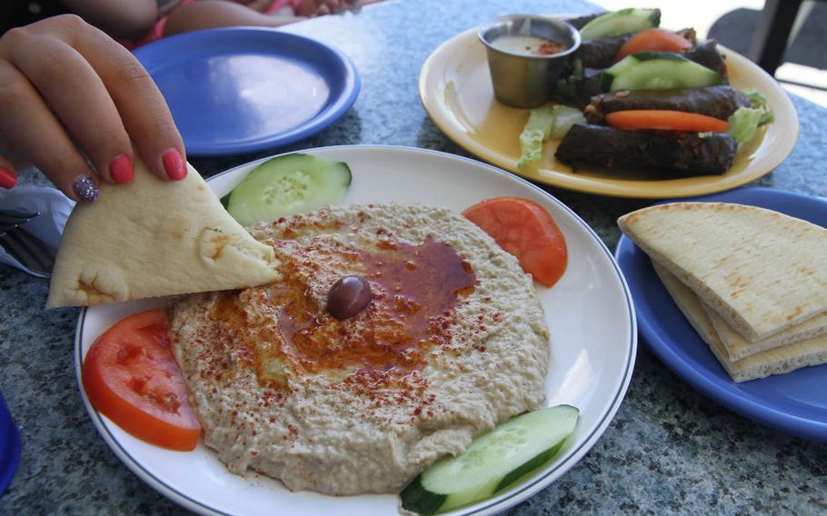 More baba ganouj than you can shake a pita bread at: a tasty blend of baked eggplant, tahini, lemon, garlic and cumin. The dish in the background is steamed grape leaves.