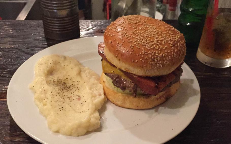 The Kevin Bacon Burger at Whoopi Gold Burger in Tokyo's Shibuya district features a large, thin patty topped with two thick slices of sweet and smoky bacon, lettuce, tomato, onion and mild cheddar cheese. Diners can choose between french fries or mashed potatoes sprinkled with pepper and bits of bacon.