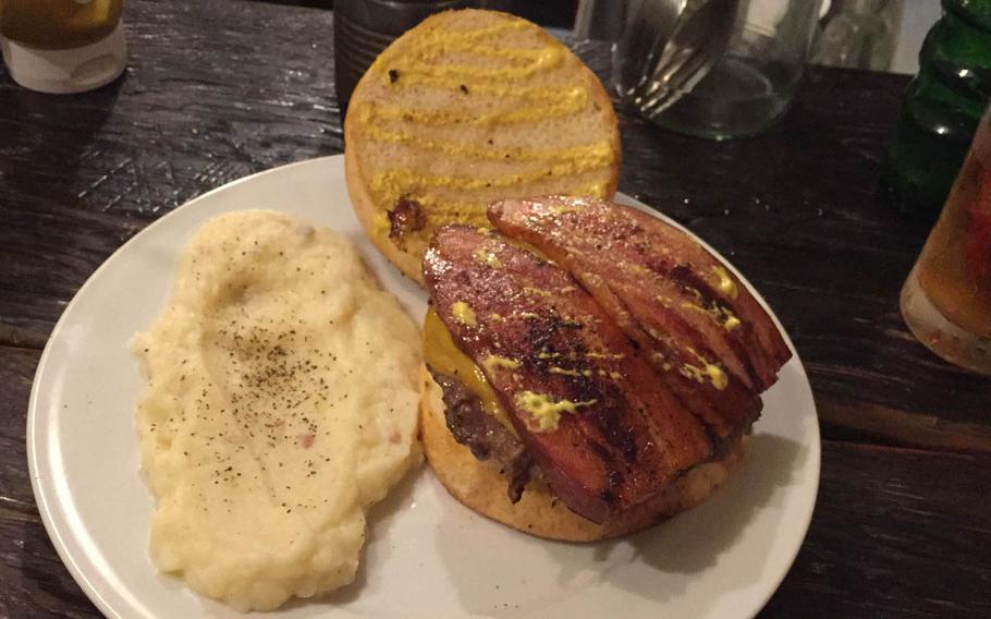 The Kevin Bacon Burger at Whoopi Gold Burger in Tokyo's Shibuya district features a large, thin patty topped with two thick slices of slightly-sweet and smoky bacon, lettuce, tomato, onion and mild cheddar cheese. Diners can choose french fries or mashed potatoes sprinkled with pepper and bits of bacon.