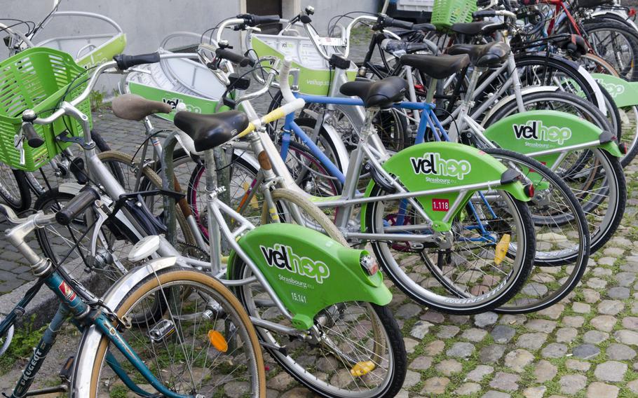 Bicycles from the bike rental service Velhop sit in a square in Strasbourg, France. Visitors can rent bikes for around 5 Euro for up to 12 hours, allowing them to see more of the city.