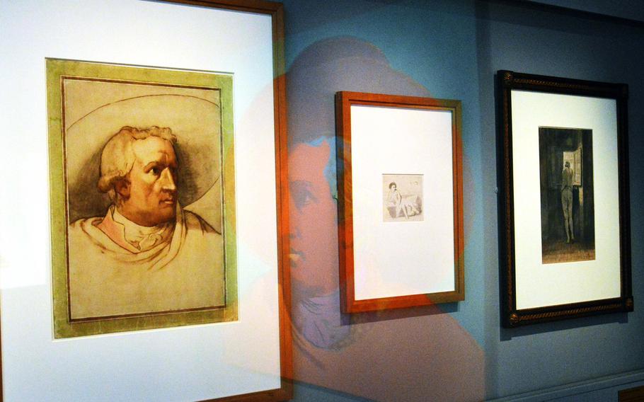 The Stadel's "Johann Wolfgang von Goethe" by Andy Warhol is reflected in the glass protecting other works depicting the German poet and author, including Johann Heinrich Wilhelm Tischbein's "Johann Wolfgang von Goethe in the Campagne" from the Goethe-Nationalmuseum in Weimar, Germany, left. They are on display  at the "Masterworks in Dialogue" exhibit at the Staedel in Frankfurt, Germany. 