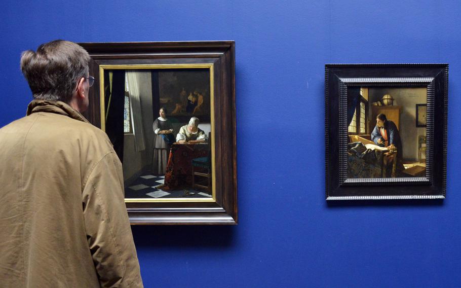 A visitor to the "Masterworks in Dialogue" exhibit at the Staedel in Frankfurt, Germany, studies works by Johannes Vermeer. To celebrate its 200th anniversary, the museum brought masterpieces from other museums to display with works of its own. At left is "A Lady Writing a Letter with her Maid" from the National Gallery of Dublin, Ireland, and the Staedel's "The Geographer," at right.