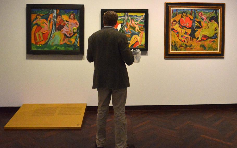A visitor to the "Masterworks in Dialogue" exhibit at the Staedel in Frankfurt, Germany, views paintings by Ernst Ludwig Kirchner, Max Pechstein and Erich Heckel. To celebrate its 200th anniversary, the museum brought masterpieces from other museums to display with works of its own. Kirchner's "Forest Scene," left, belongs to the Staedel, while the work with the same name by Pechstein is from a private collection and Heckel's "Group Outdoors" is from the Merzbacher Kunststiftung.