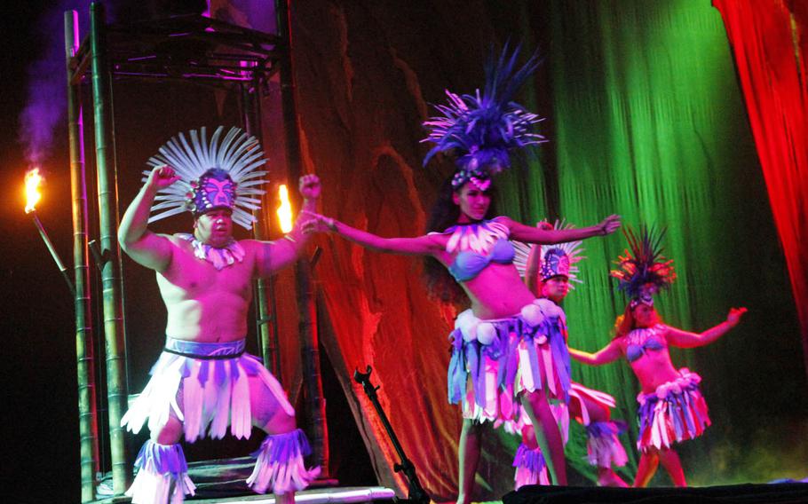 Costumed dancers perform a routine as part of the Magic of Polynesia show in Honolulu.
