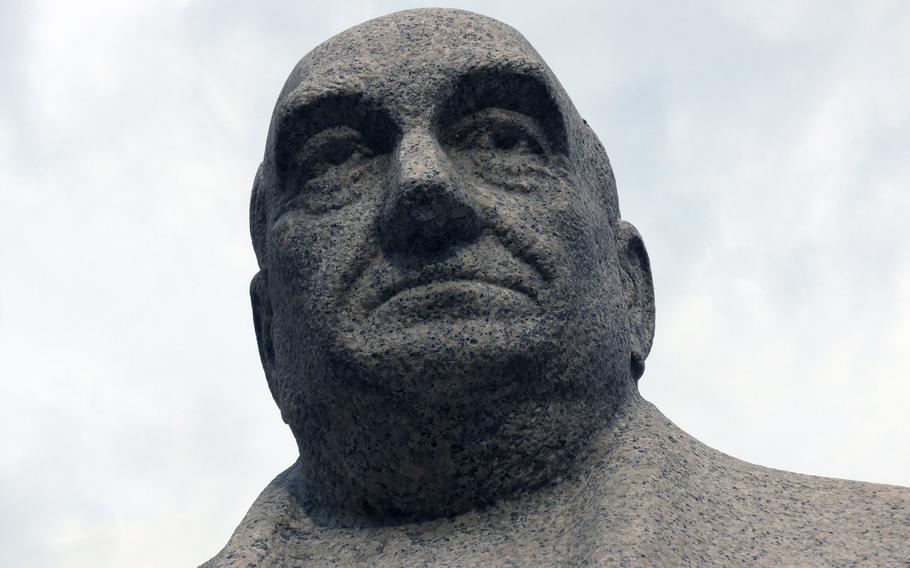 Polish theater and film director Leon Schiller looks down on Piotrkowska Street, the main pedestrian shopping street in Lodz, Poland. A variety of statues line the street and connecting squares along with shops, cafes and bars.