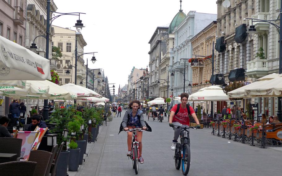 Bicyclists roll down Piotrkowska Street in Lodz, Poland. Bikes and bike-powered rickshaws are normally the only vehicles allowed to travel on the city's pedestrian shopping street. Known as "P Street" by the Americans at nearby Lask Air Base, the street features many statues, along with shops, bars and restaurants.