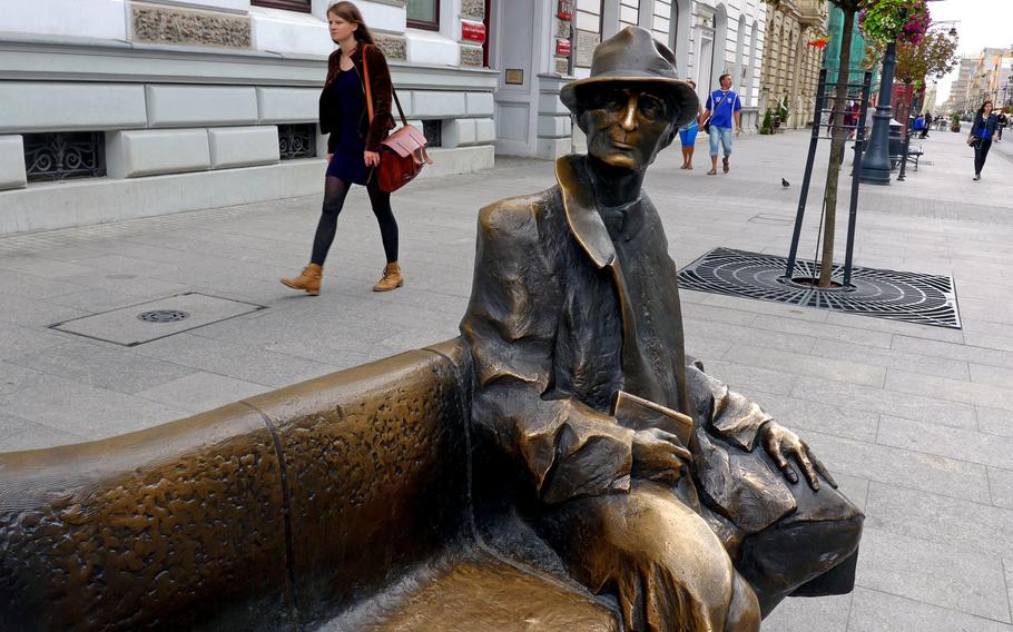 A statue of Polish poet Julian Tuwim looks down Piotrkowska Street from his bench on Lodz, Poland's popular pedestrian shopping street.