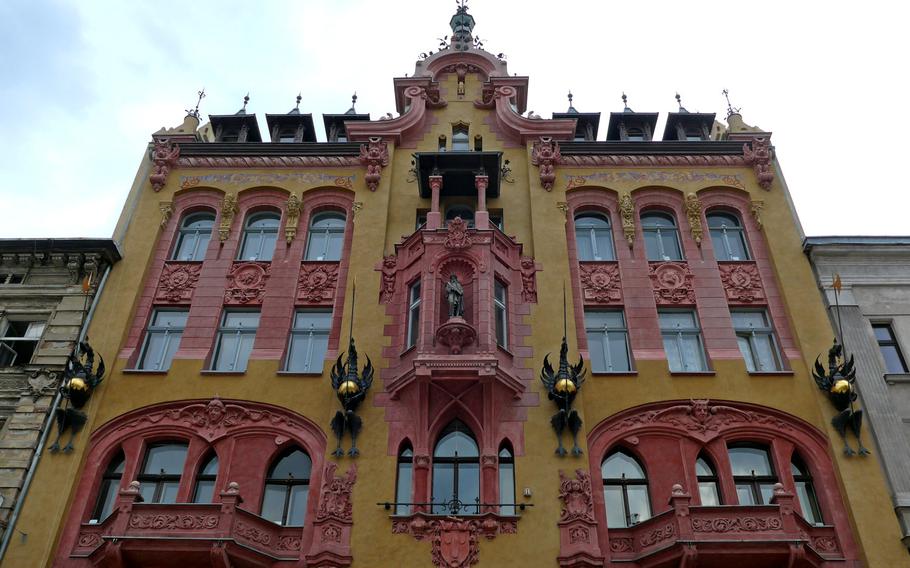 The Gutenberg House on Piotrkowska Street in Lodz, Poland. Built at the end of the 19th century -- although you couldn't tell with the dragons adorning it -- the building was once owned by a publisher. Perhaps that is why Johannes Gutenberg, the inventor of the movable-type printing press is featured in the nook at the center of the facade.