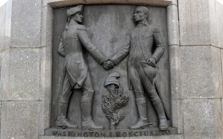 At the base of the  Tadeusz Kosciuszko Monument, the Polish hero, right, shakes hands with George Washington. Kosciuszko fought with the Continental Army during the Revolutionary War, and as an architect oversaw the construction of American fortifications. 
The monument stands on Wolnosci Square in downtown Lodz, Poland, at the top of Piotrkowska Street, the city's main pedestrian shopping street.