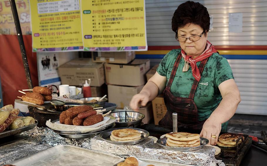Many booths at Tong Bak Market in Pyeongtaek, South Korea, are small restaurants serving traditional Korean snacks and fried foods. This vendor runs one of the more popular booths and serves everything from the sweet pancakes called hotteok to the Korean blood sausage soondae.
