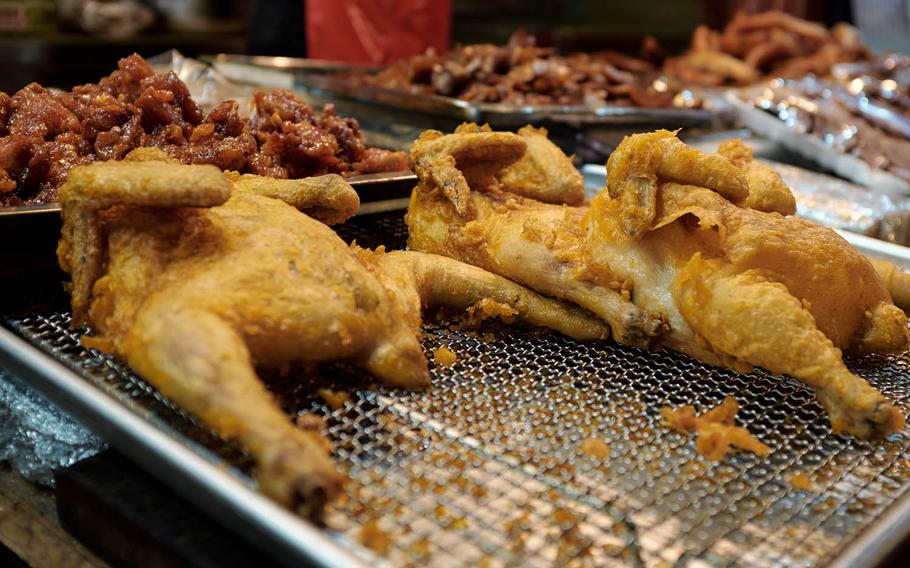 South Korea is famous for its fried chicken. At Tong Bak Market in the port city of Pyeongtaek, half-cooked whole fried chickens are on display. For less than $7, the vendor will cook a customer's chicken of choice.