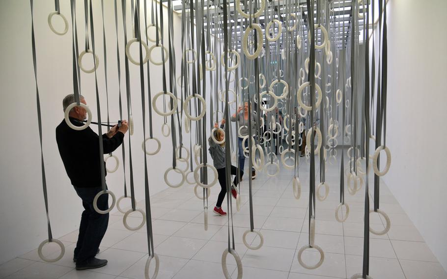 Visitors climb through William Forsythe's "The Fact of the Matter," from an exhibit of the same name at the Museum fuer Modern Kunst in Frankfurt, Germany. The exhibit at the city's modern art museum runs until Jan. 31, 2016.