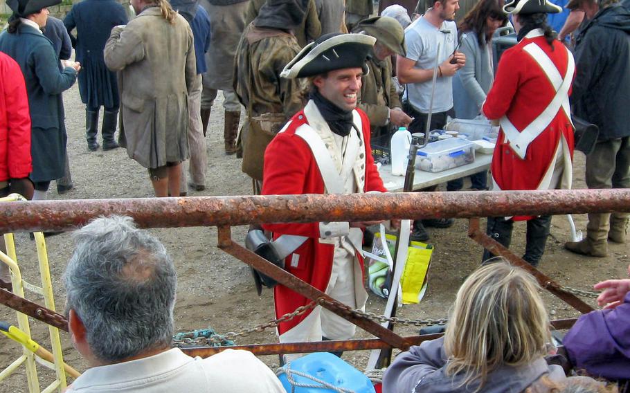 Noah Ball of Falmouth, Cornwall, turns away from the tea table on the set of "Poldark" in Charlestown to chat with onlookers watching filming from behind barriers.
