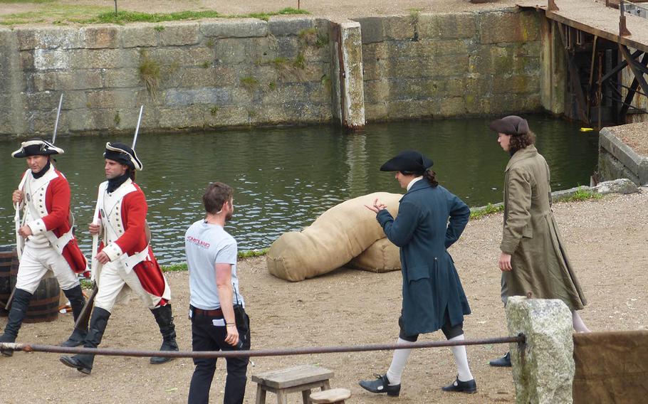 The director chats with actors during a break in filming. The port city of Charlestown is virtually unchanged since the 18th century, and thus makes a natural "set" for the action.