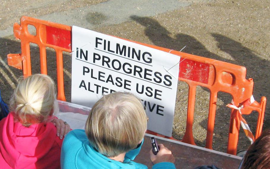 Onlookers are kept behind barriers during filming of scenes from the second season of the BBC's "Poldark" in Charlestown, a port city in the county of Cornwall, England.