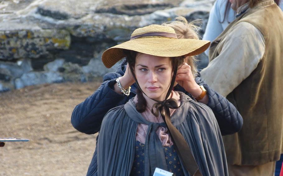 An extra gets a wardrobe adjustment before filming a scene for the 2015 remake of the BBC's "Poldark" in Charlestown.