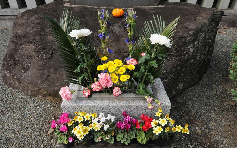 A flower arrangement decorates a grave at Tama Reien, a large park-like cemetery in western Tokyo that boasts wide, tree-lined streets and walkways that attract joggers, cyclists, dog-walkers, picnickers, bird-watchers and sightseers.