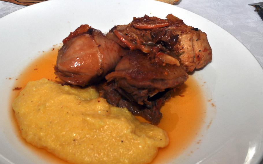 This dish featuring pieces of chicken with a side of polenta is the house special at Trattoria Da Carmelo in Pasiano, Italy."Pollo in Tecia" comes from a family recipe.