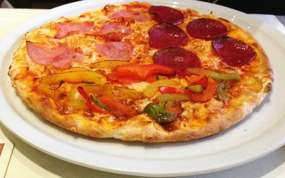 A three-topping pizza is served at La Nave, an Italian restaurant and pizzeria in Alzey, Germany.