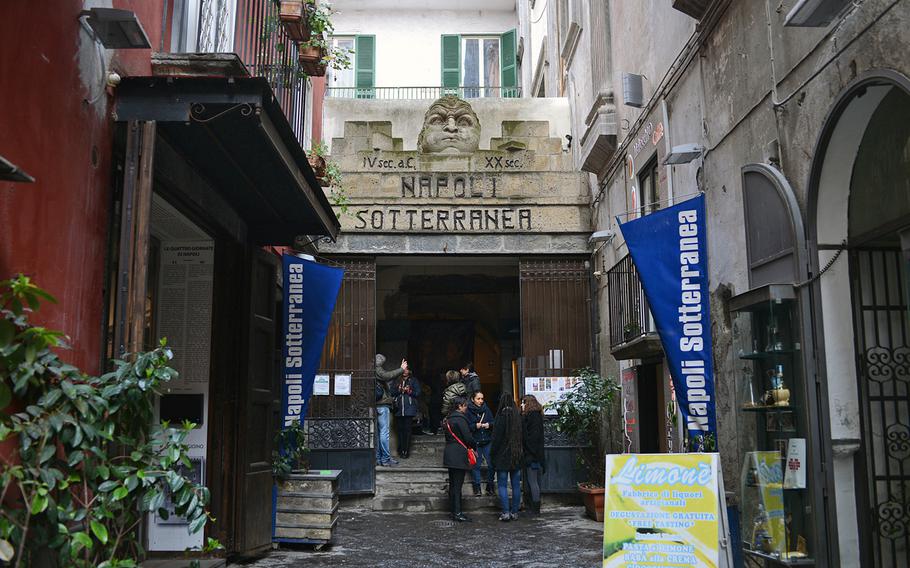 Tourists wait at the entrance to Napoli Sotterranea, or Naples Underground, a tour of ancient aqueducts later used as bomb shelters during World War II. English-speaking tours of the underground are held every two hours.