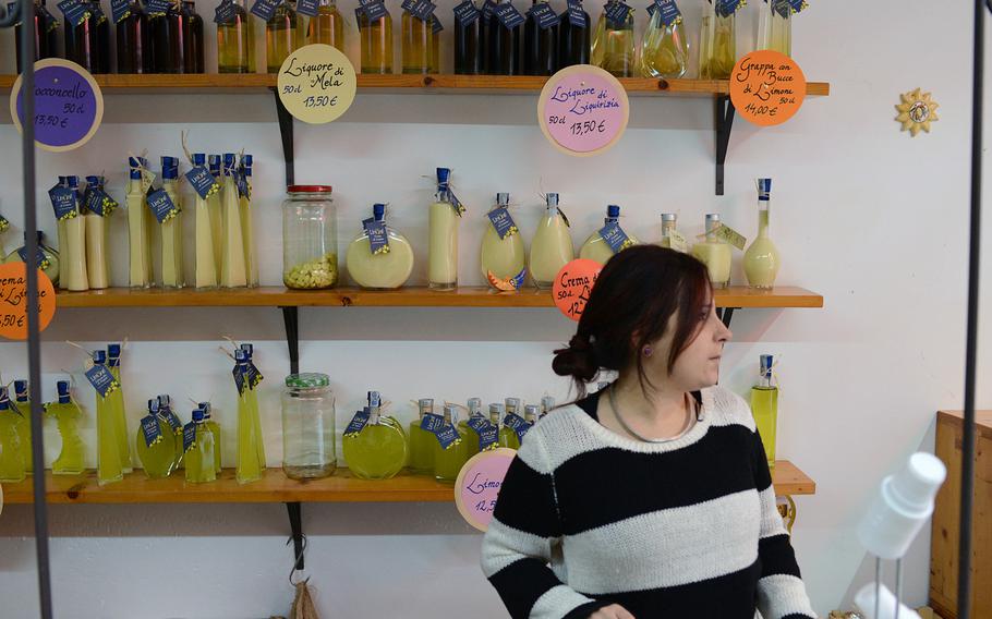 Roberta Formisano is flanked by shelves of limoncello at Limone, a small producer of the liqueur off Via dei Tribunali in downtown Naples..