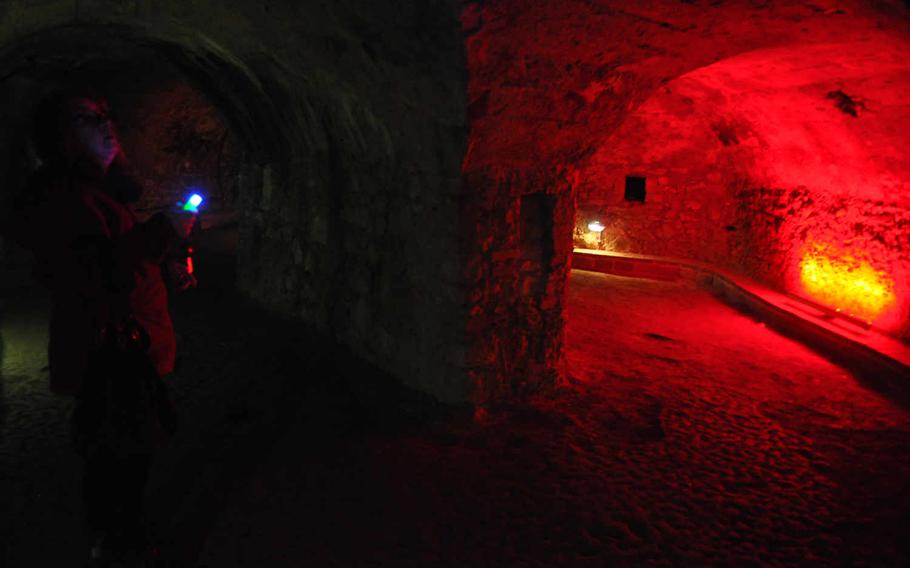 Annette Pender, an Oppenheim native who occasionally gives tours of the cellar labyrinth, stands with a flashlight on Feb. 23, 2016, inside a section of the underground tunnels and cellars open to the public.