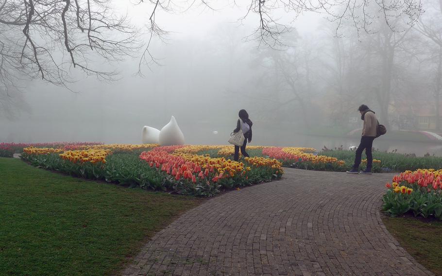 Visitors walk through a quiet Keukenhof on a foggy spring morning, Apr. 10, 2015. Even if the sun is not shining, the grounds are a place of contemplative beauty.