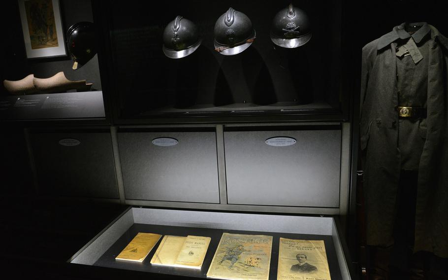 A display of soldiers' items and equipment on display at the Verdun Memorial Museum, which is located on the World War I battlefield. To expand what can be displayed, visitors can pull out drawers that hold more items, like these magazines and pamphlets.