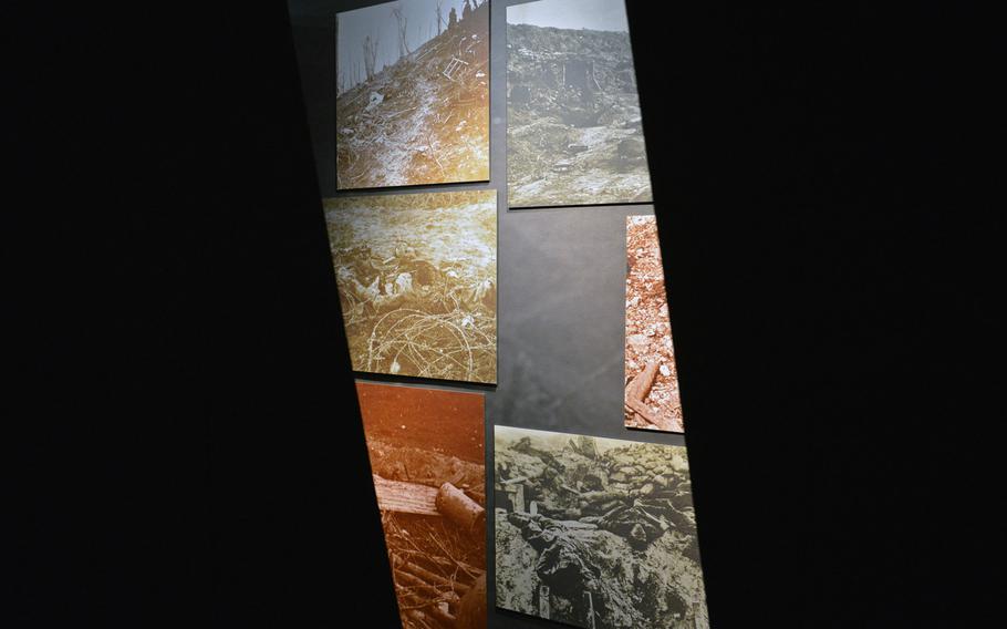The dead of the Battle of Verdun can be seen in photographs in a gap between walls of a display at the Verdun Memorial Museum at Fleury-devant-Douaumont, France.